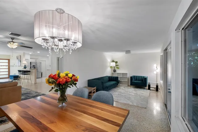 a living room with furniture a chandelier and a chandelier