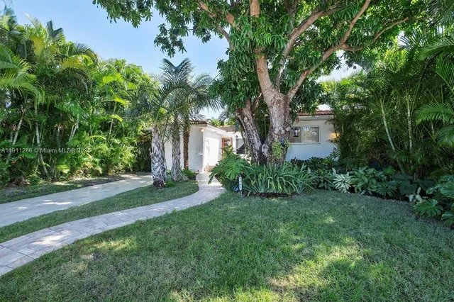 a view of a house with a tree in a yard