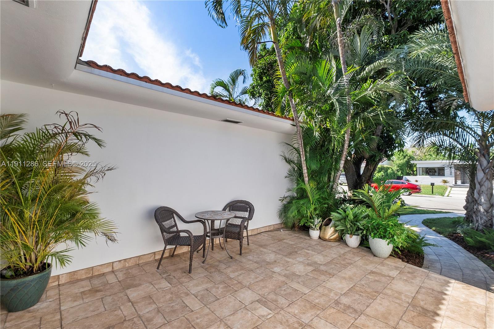 9049 Dickens Avenue Surfside, FL 33154 - Photo 3 of 34 a couple of table and chairs in patio