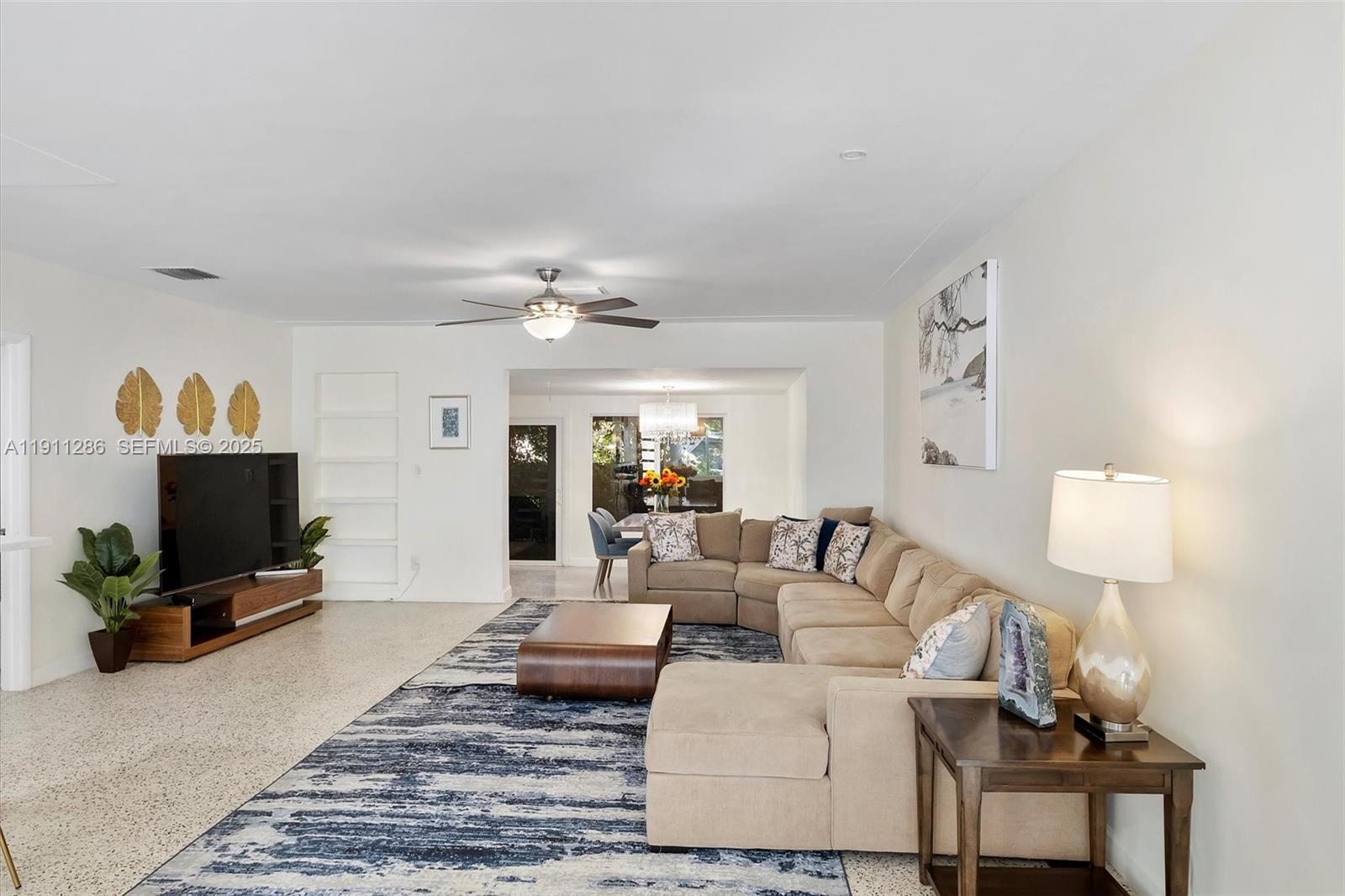 9049 Dickens Avenue Surfside, FL 33154 - Photo 6 of 34 a living room with furniture and a flat screen tv