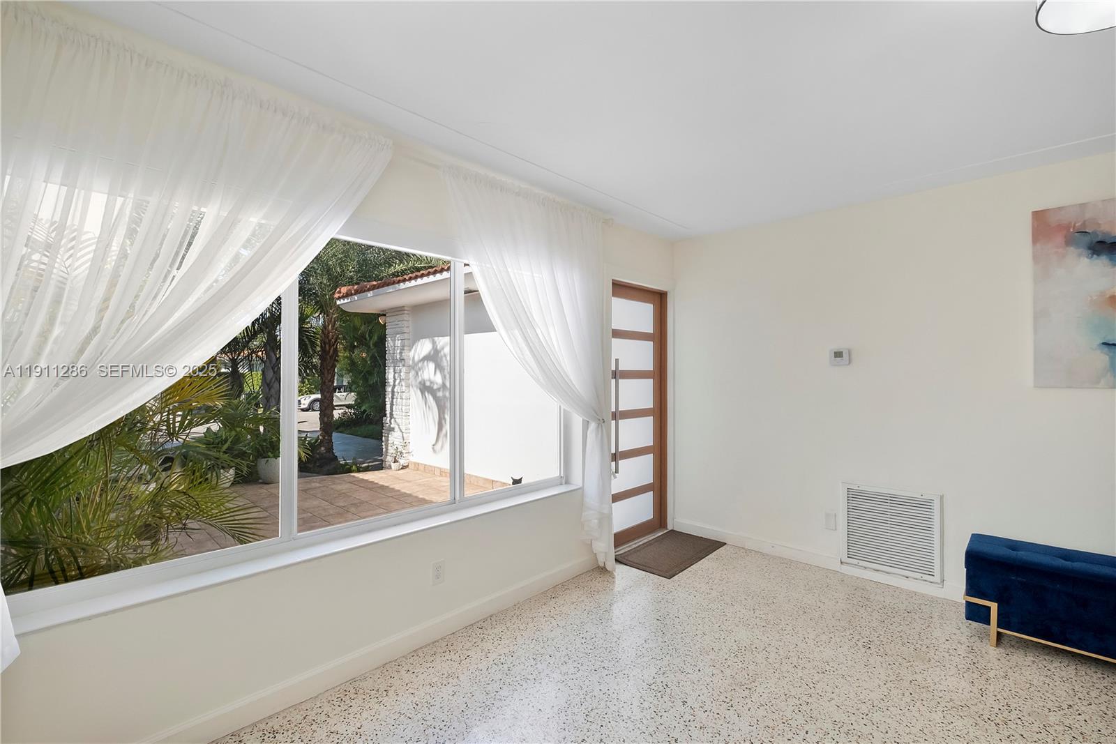 9049 Dickens Avenue Surfside, FL 33154 - Photo 8 of 34 wooden floor in an empty room with a window