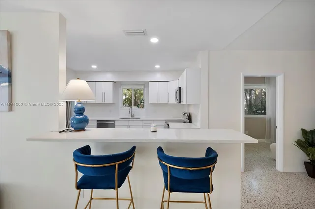 a kitchen with a dining table and chairs