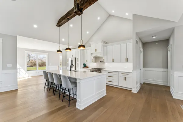 a kitchen with a table chairs stove and cabinets