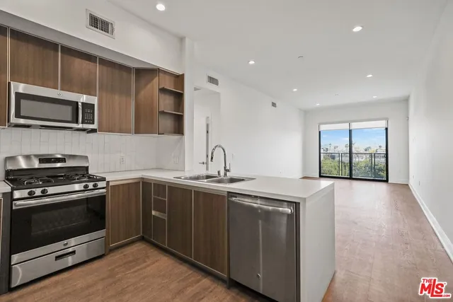 a kitchen with stainless steel appliances granite countertop a stove and a sink