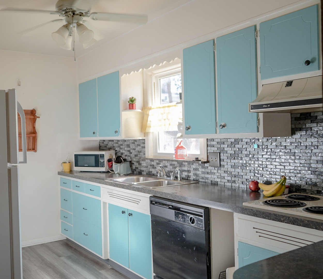 1843 31st Street Rock Island, IL 61201 - Photo 5 of 9 a kitchen with stainless steel appliances white cabinets sink and a dishwasher