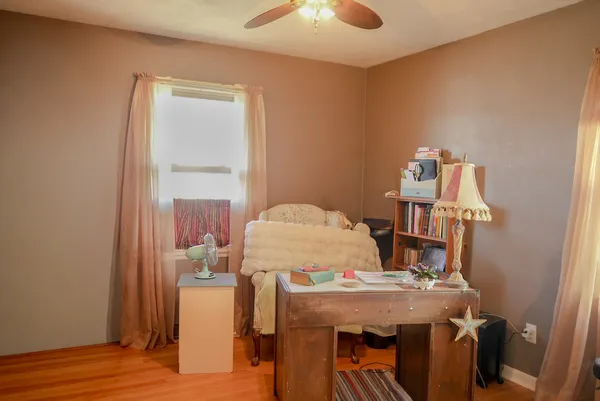 a view of a room with a table and chairs