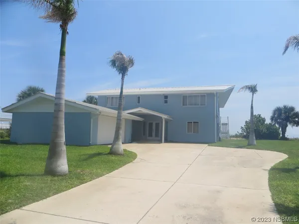 a view of a house with a yard and garage