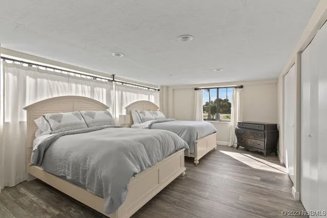 a spacious bedroom with two beds and a couch