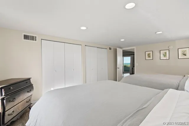 a bedroom with a bed and a night stand