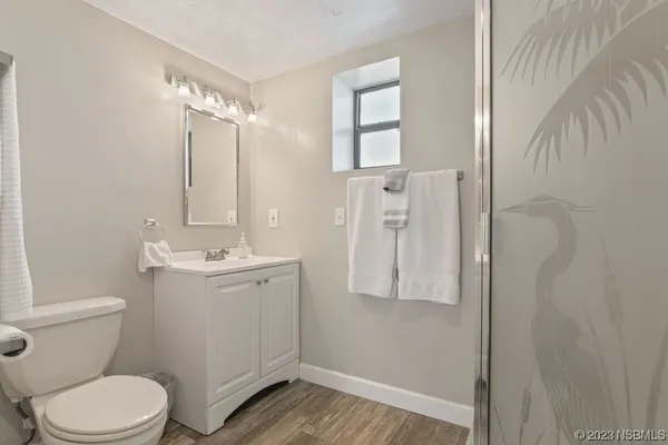 a bathroom with a toilet a sink and shower
