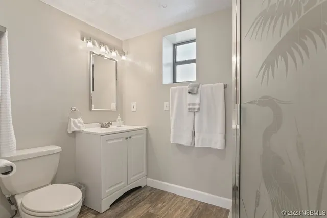 a bathroom with a toilet a sink and shower