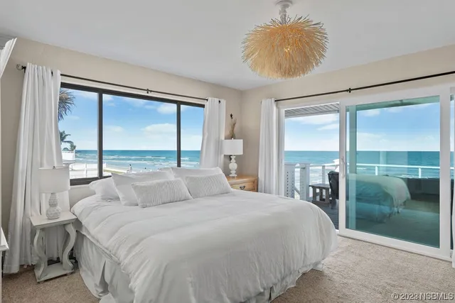 a bedroom with a large bed and a large window