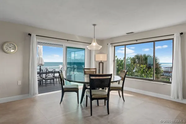 a dining room with furniture window and outside view