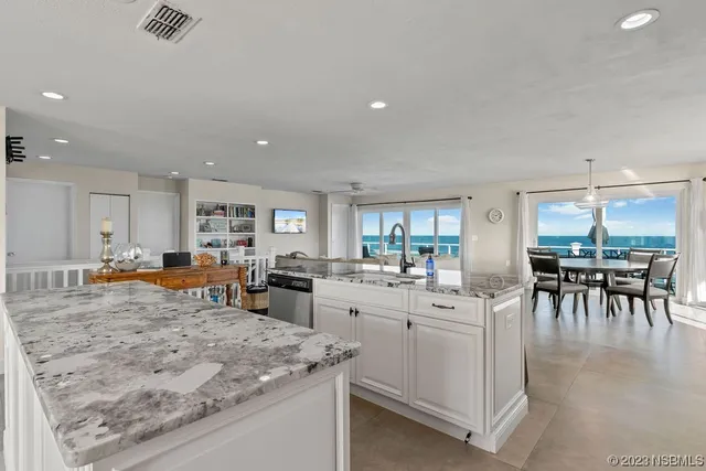 a view of a kitchen with dining table and chairs
