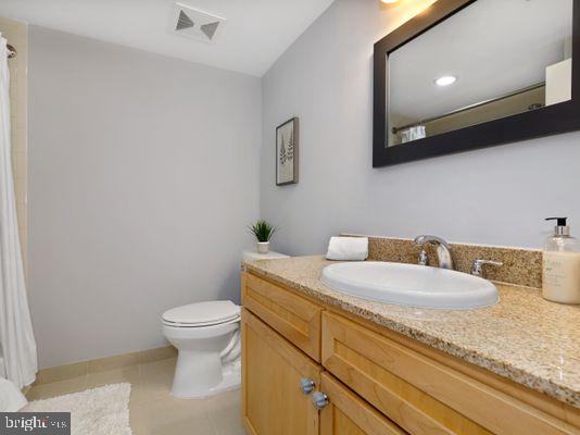 1150 K Street Northwest, Unit 709 Washington, DC 20005 - Photo 19 of 25 a bathroom with a granite countertop toilet and sink