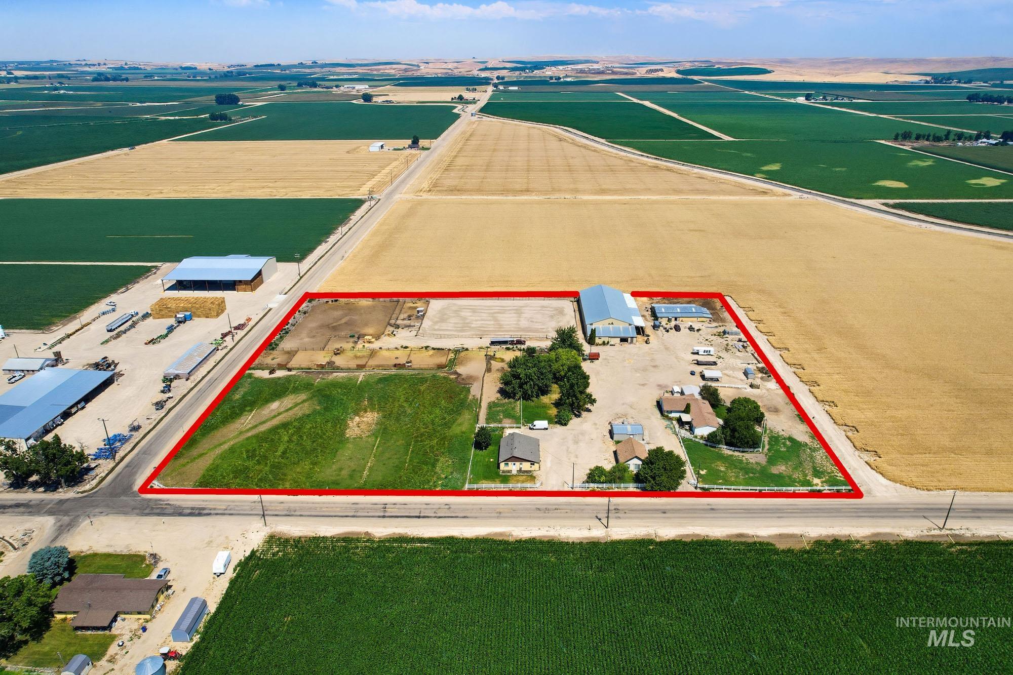 24900 Market Road Parma, ID 83660 - Photo 31 of 50 Expansive rural property featuring multiple agricultural buildings, a large open field, and several residential structures