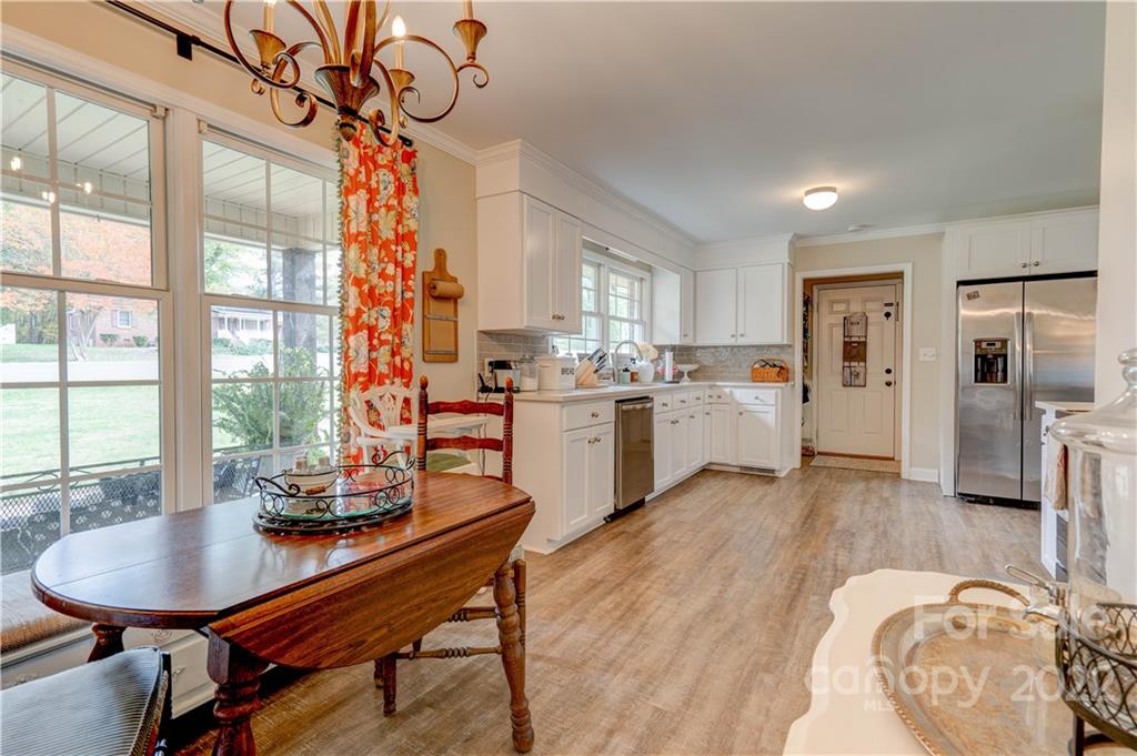 509 Roy Eaker Road Cherryville, NC 28021 - Photo 15 of 43 a kitchen with a table chairs refrigerator and cabinets