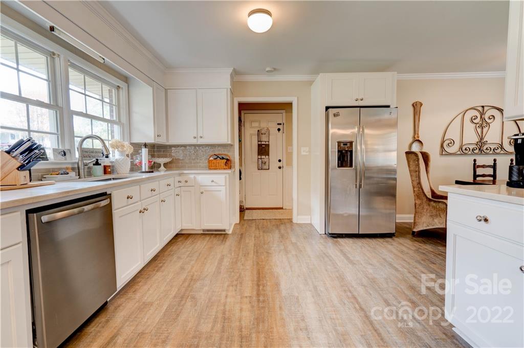 509 Roy Eaker Road Cherryville, NC 28021 - Photo 16 of 43 a kitchen with stainless steel appliances a sink cabinets and wooden floor