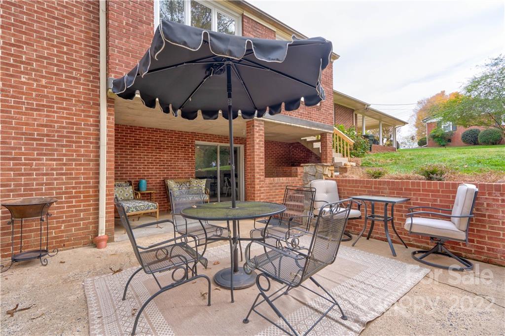 509 Roy Eaker Road Cherryville, NC 28021 - Photo 6 of 43 a view of a patio with a table and chairs under an umbrella