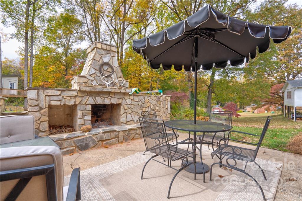 509 Roy Eaker Road Cherryville, NC 28021 - Photo 7 of 43 a view of patio with chairs and table under an umbrella