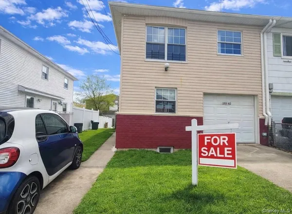 a view of a chairs and a table in a backyard