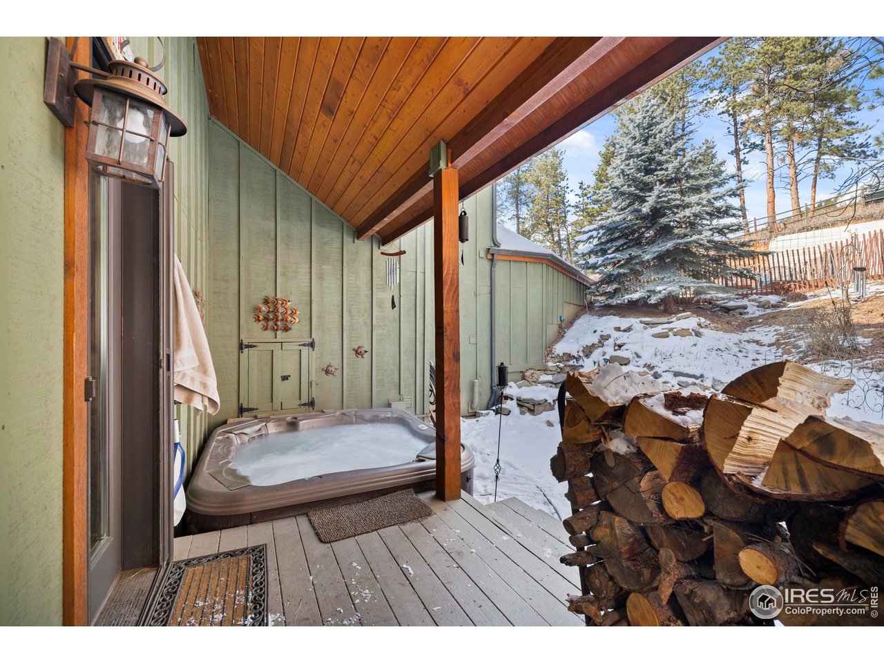 952 Skinner Gulch Road Loveland, CO 80537 - Photo 33 of 43 Porch with Step-in Hot Tub