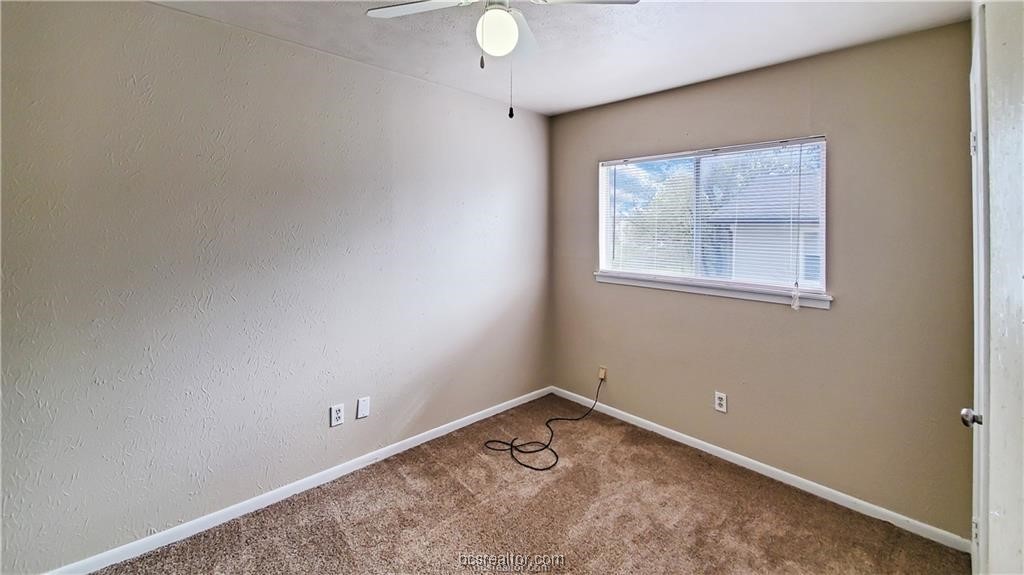 1908 Barak Lane, Unit 15 Bryan, TX 77802 - Photo 6 of 9 an empty room with a window