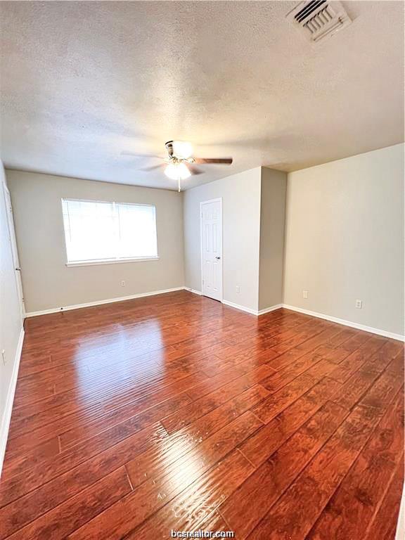 1908 Barak Lane, Unit 15 Bryan, TX 77802 - Photo 7 of 11 a view of an empty room with wooden floor and a window