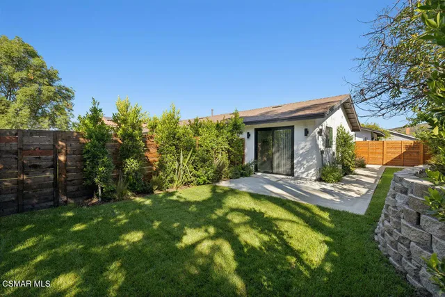 a view of an house with backyard space and garden
