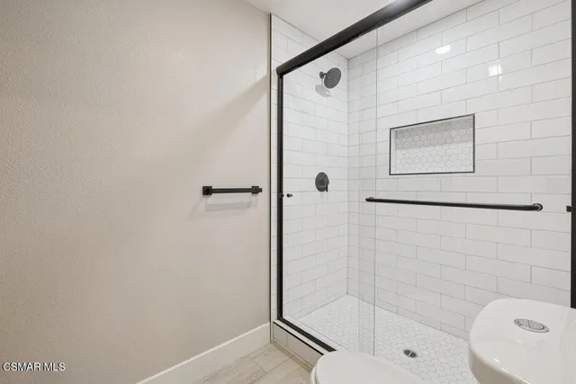 a bathroom with a shower and toilet