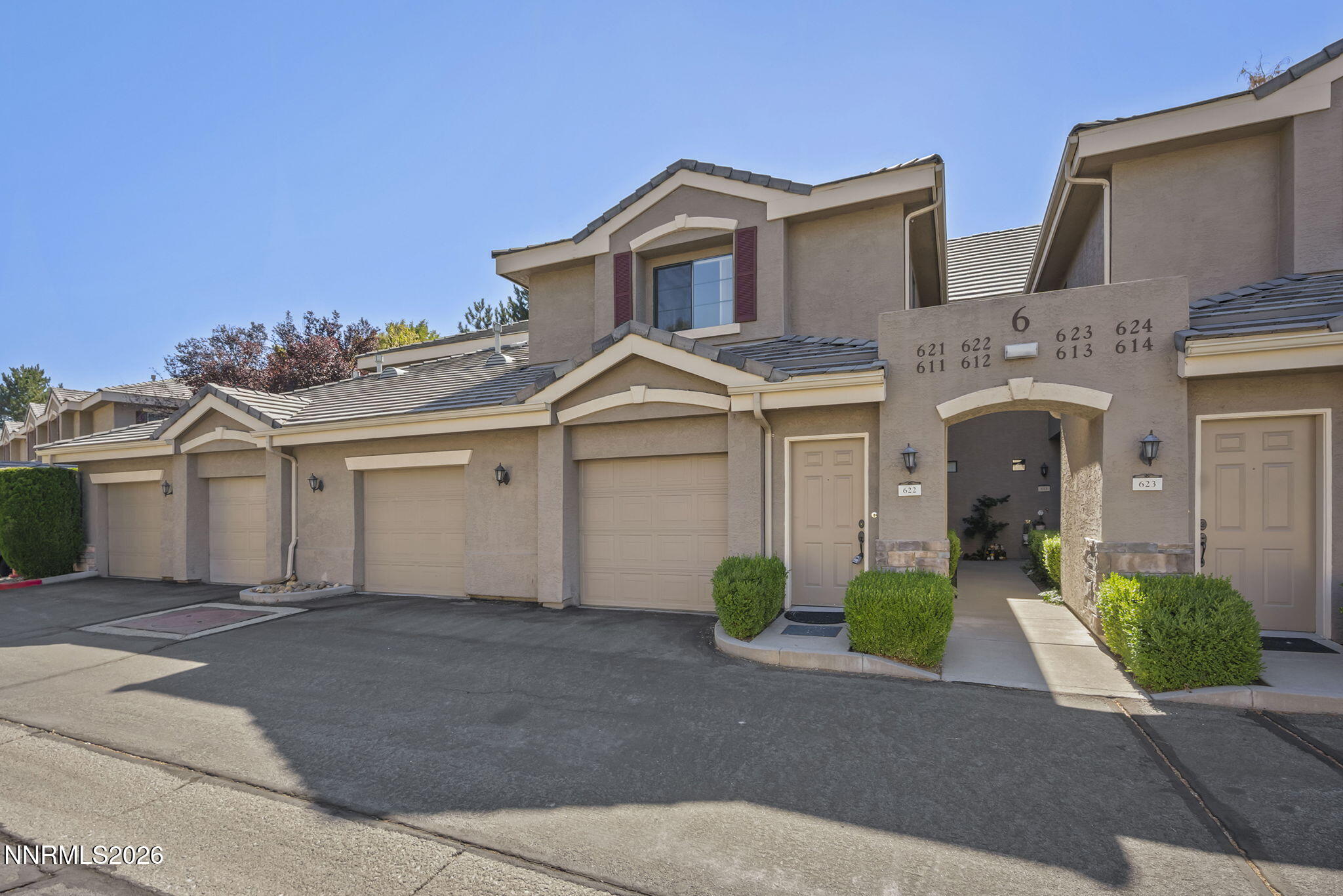 900 South Meadows Parkway, Unit 622 Reno, NV 89521 - Photo 1 of 30 a front view of a house with a yard and garage