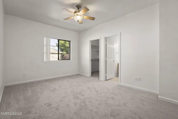 an empty room with windows and closet