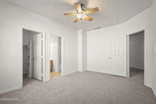 a view of a big room with chandelier fan and closet area