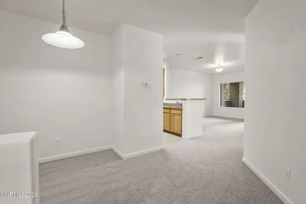 a view of a kitchen with a sink and a refrigerator