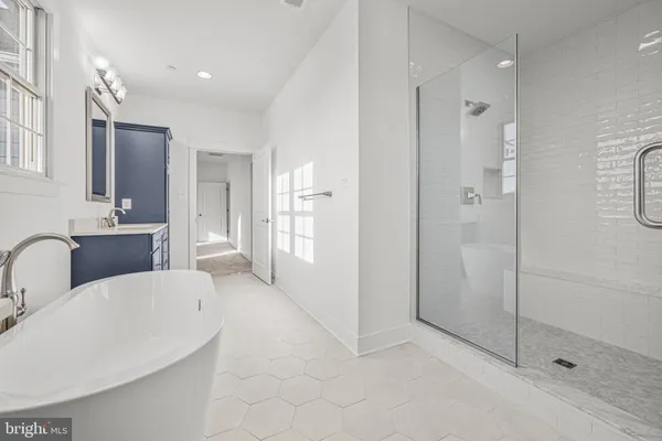 a large bathroom with a tub and shower