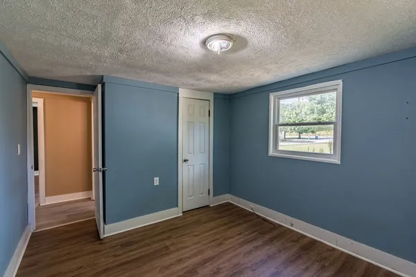 an empty room with a empty space and windows