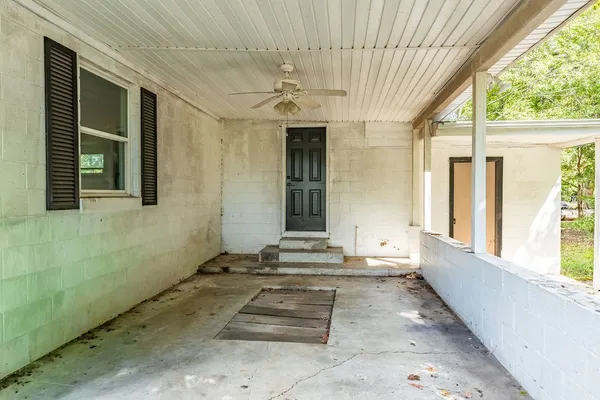 a view of a door and tree in front of a house