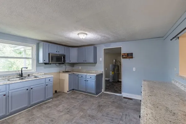 a kitchen with a sink stove and cabinets