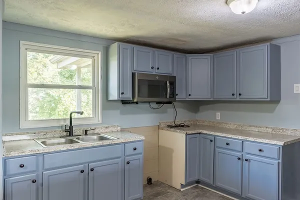 a kitchen with sink cabinets and window