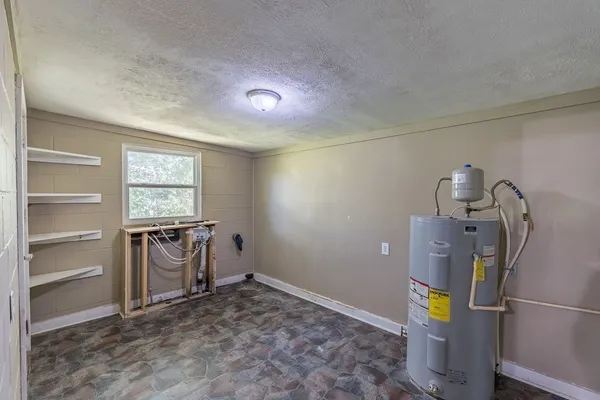 a view of a storage & utility room with a window