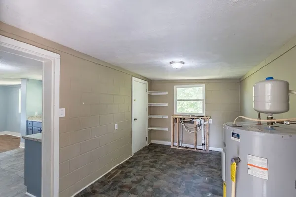 a large kitchen with kitchen island a sink stainless steel appliances and cabinets