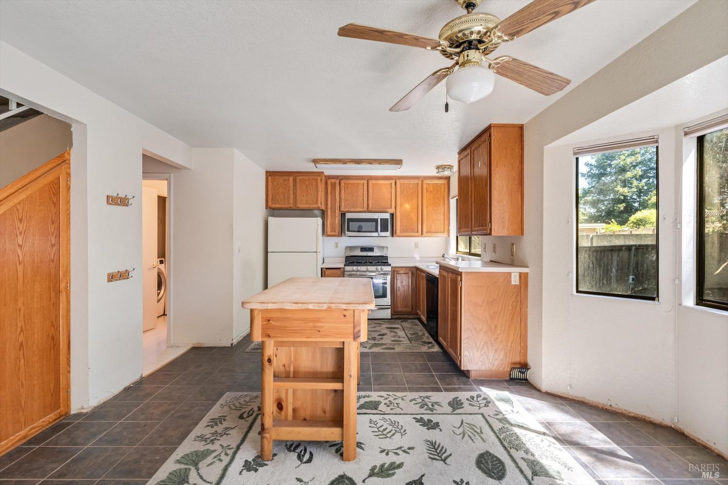 7408 Maximillian Place Rohnert Park, CA 94928 - Photo 5 of 19 Bright and functional kitchen featuring ample cabinet storage, large windows that fill the space with natural light. The open layout provides excellent flow for everyday living and entertaining, while offering a wonderful opportunity to update and customize to your personal style.