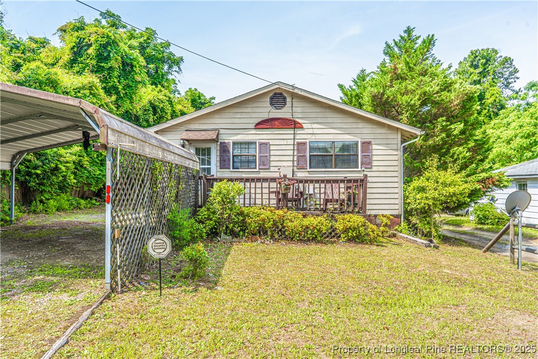 a view of a house with a yard and potted plants