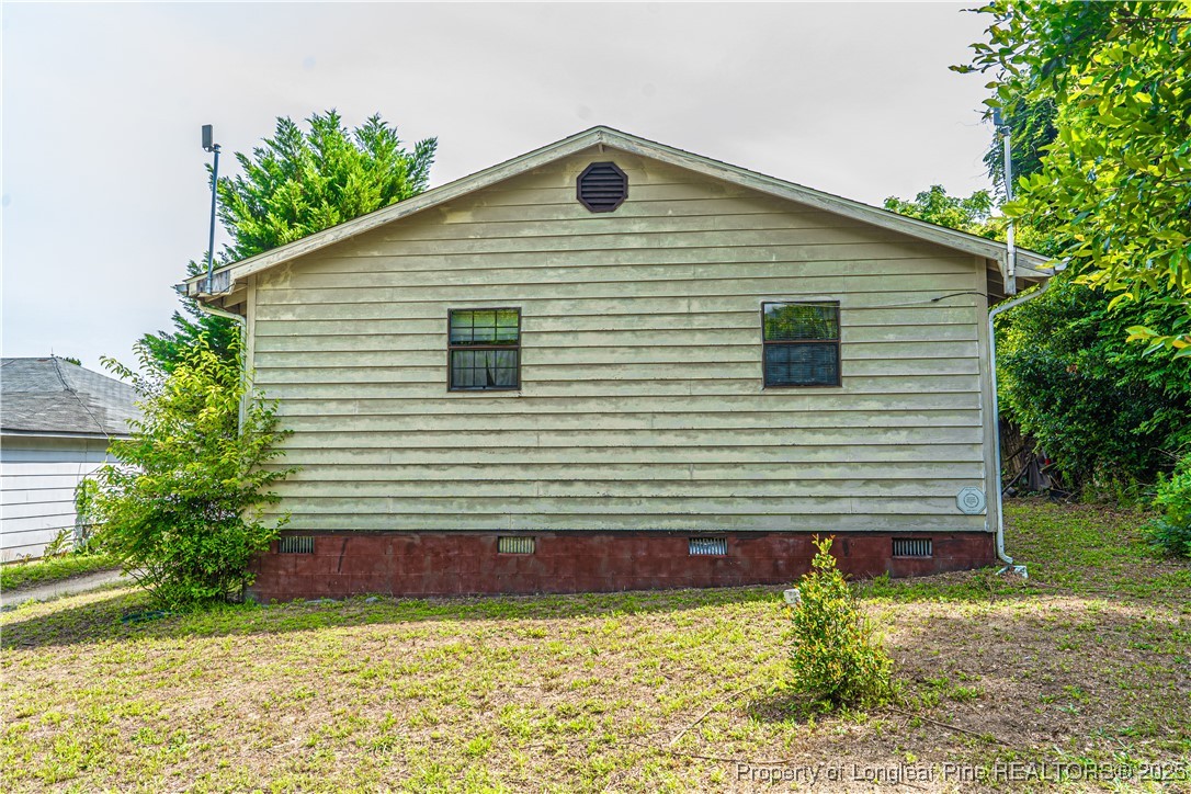 8212 Main Street West End, NC 27376 - Photo 14 of 36 a front view of a house with garden