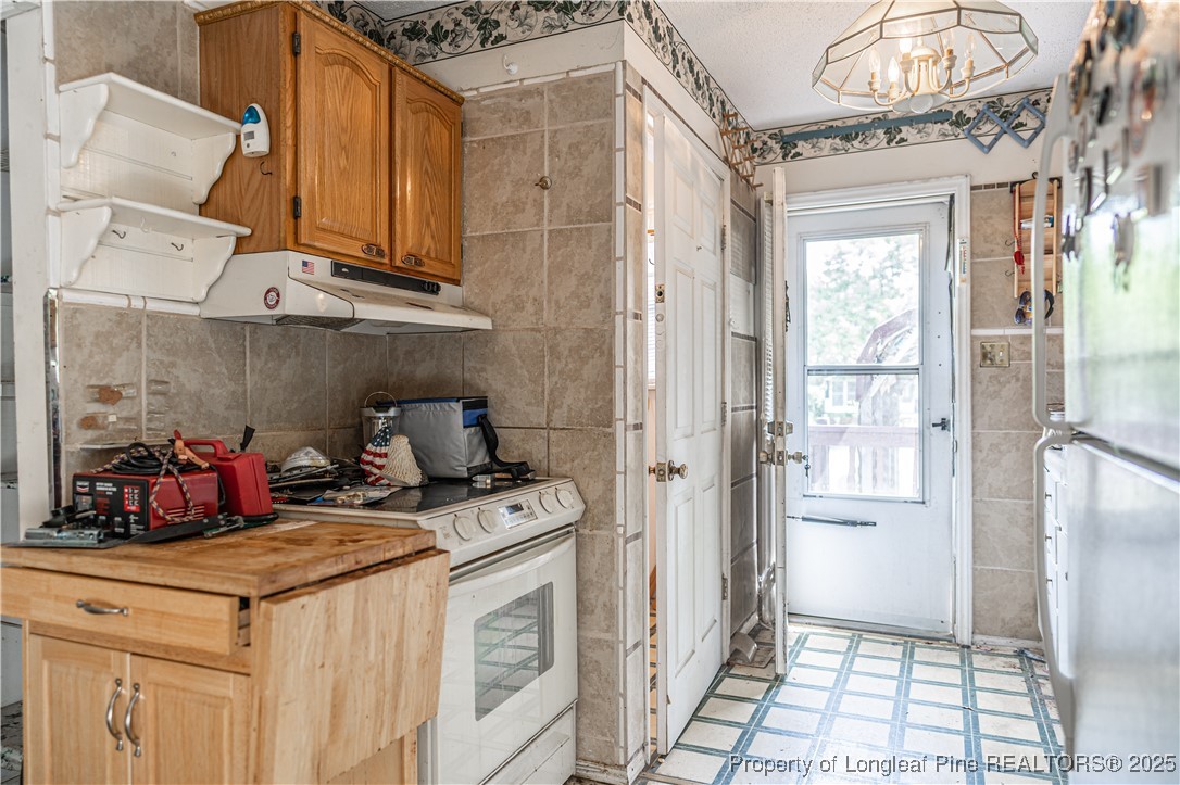 8212 Main Street West End, NC 27376 - Photo 19 of 36 a kitchen with stainless steel appliances granite countertop a stove and a refrigerator