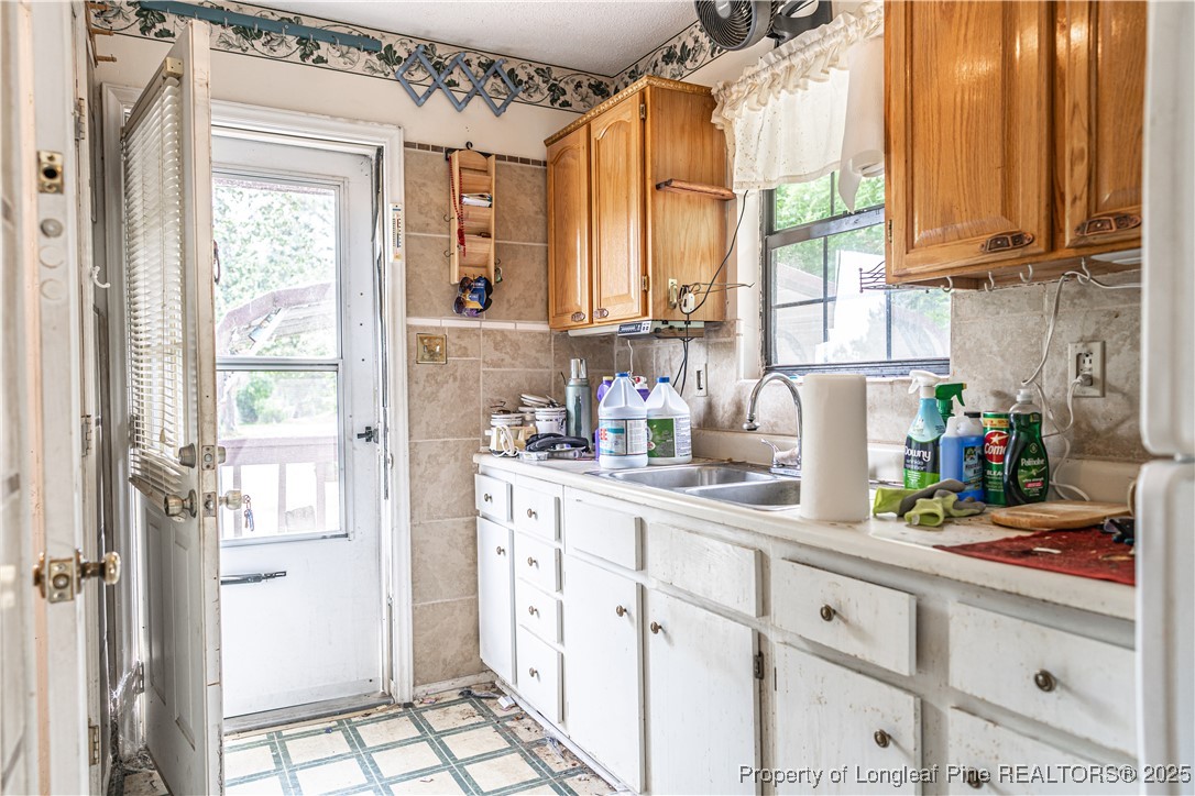 8212 Main Street West End, NC 27376 - Photo 20 of 36 a kitchen with stainless steel appliances a refrigerator and sink
