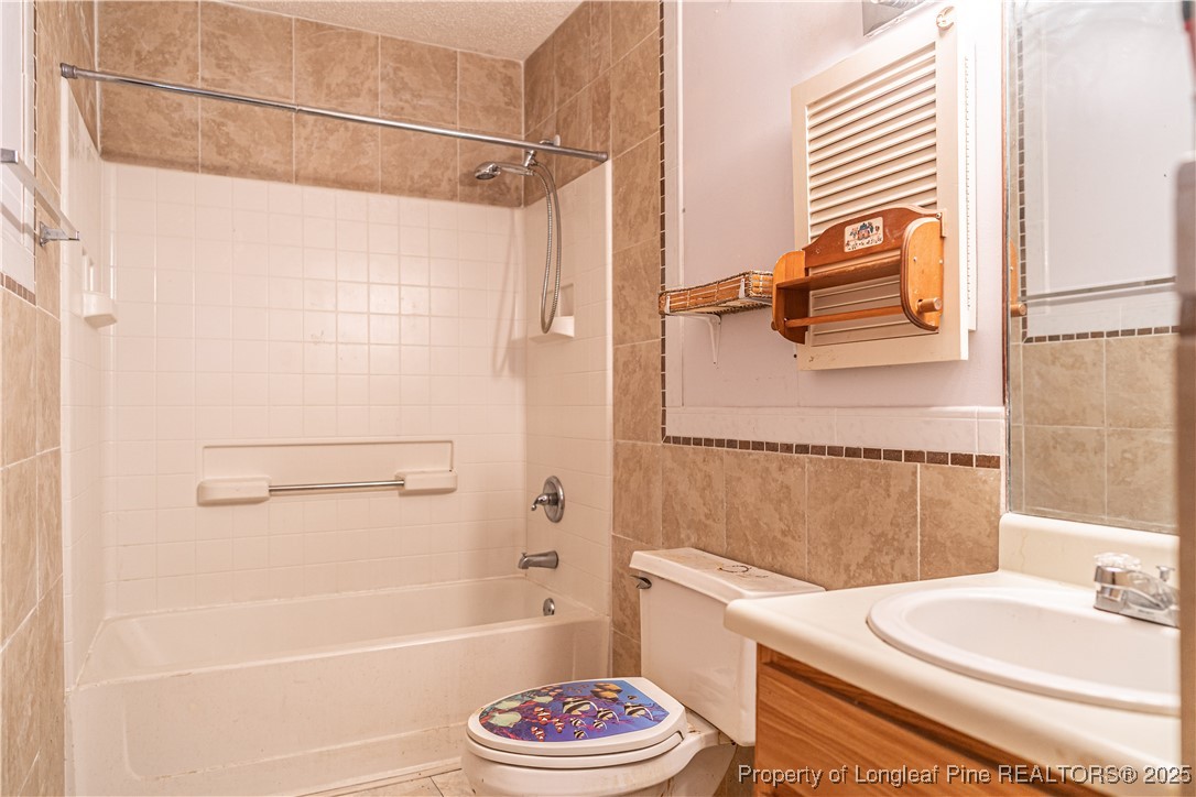 8212 Main Street West End, NC 27376 - Photo 24 of 36 a bathroom with a sink a toilet and shower
