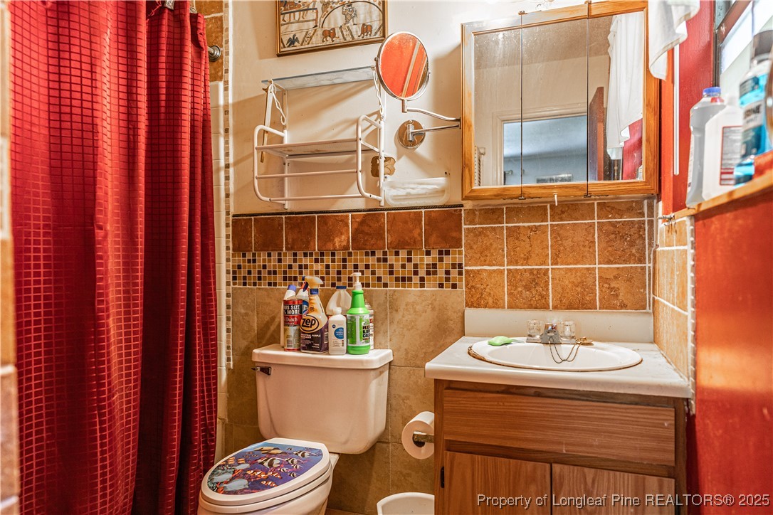 8212 Main Street West End, NC 27376 - Photo 30 of 36 a bathroom with a sink and mirror