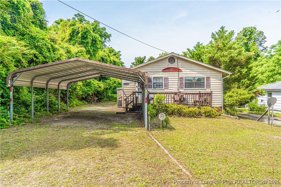 8212 Main Street West End, NC 27376 - Photo 3 of 36 a front view of a house with a yard