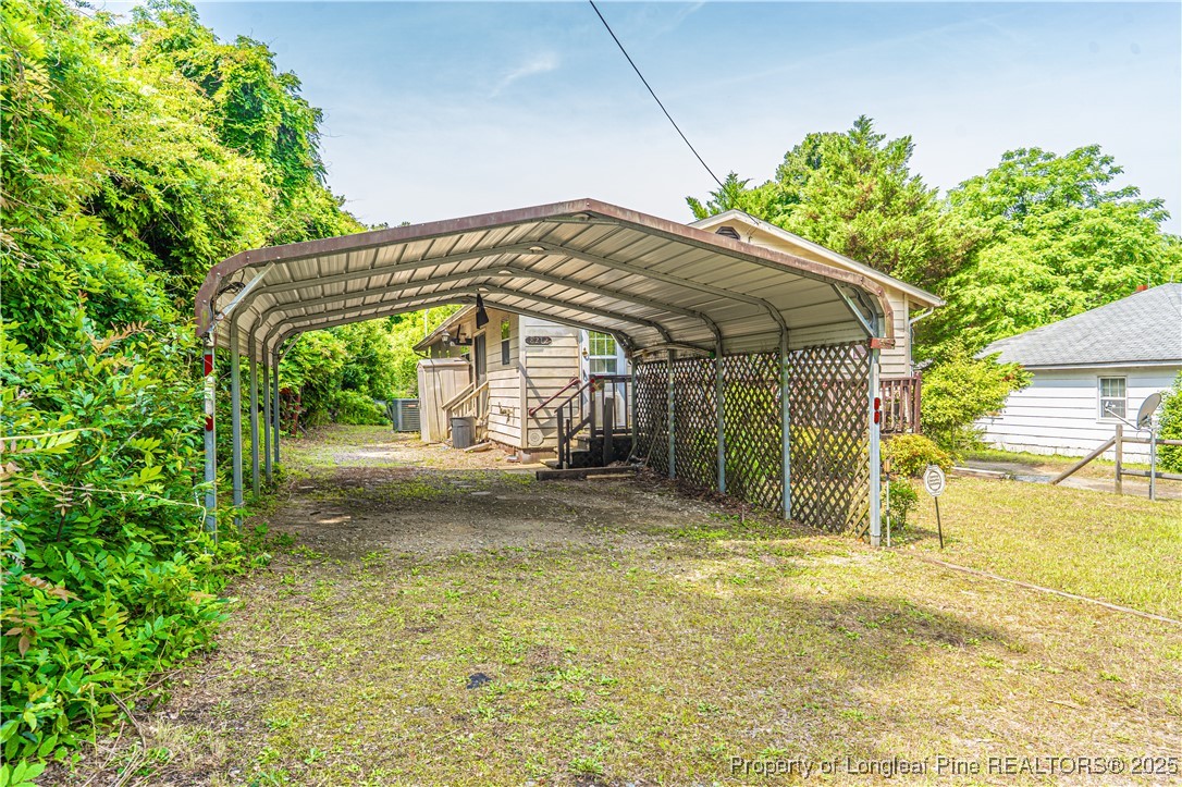 8212 Main Street West End, NC 27376 - Photo 4 of 36 a view of a house with backyard and a garden